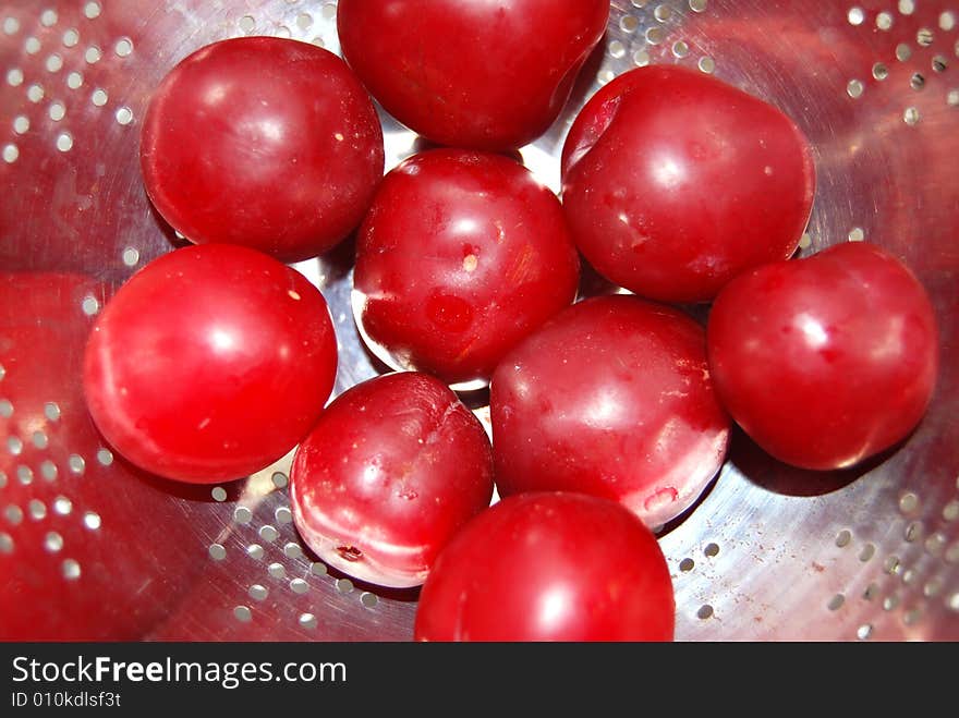 Juicy Plums In A Colander