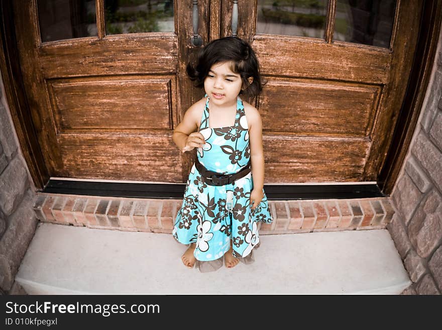 Child sitting by an antique door. Child sitting by an antique door