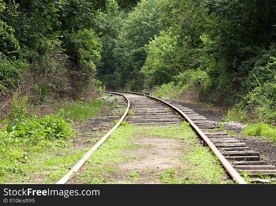 Old abandoned railroad tracks curving into the horizon