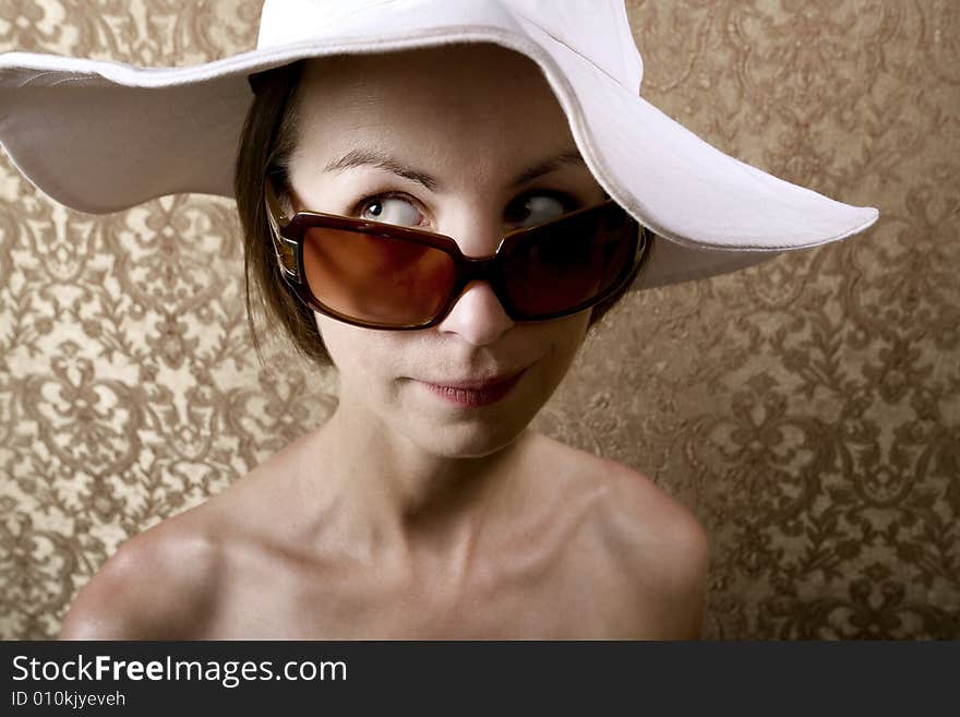 Young Woman with Sunglasses and a Floppy White Hat