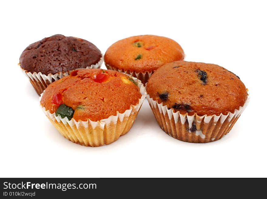 Four different flavor muffins put together on white background.