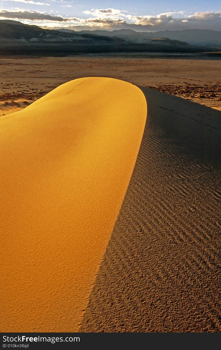 Sanddune curves under winter sky, Death Valley National Park. Sanddune curves under winter sky, Death Valley National Park