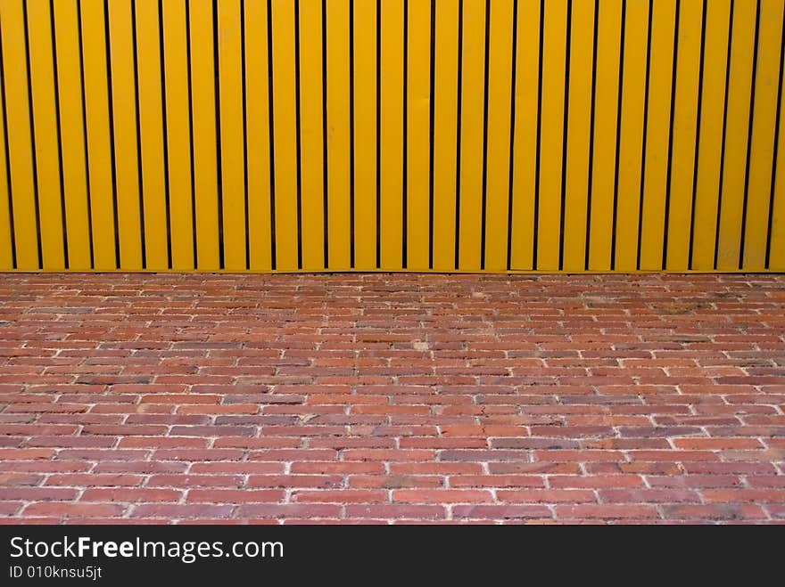 The conjoint of yellow wooden roof and red brick wall. The conjoint of yellow wooden roof and red brick wall