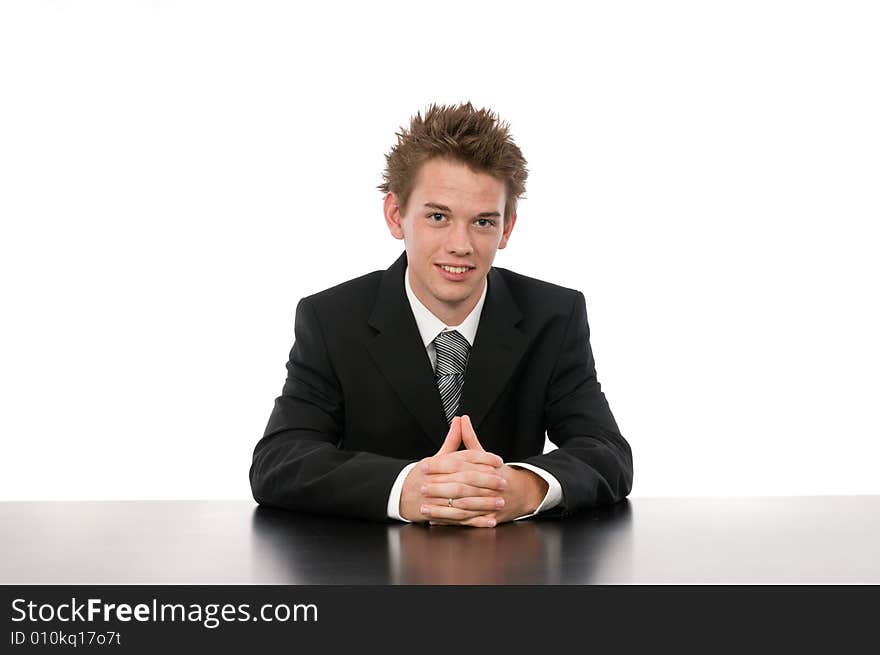 A young businessman sitting in his office