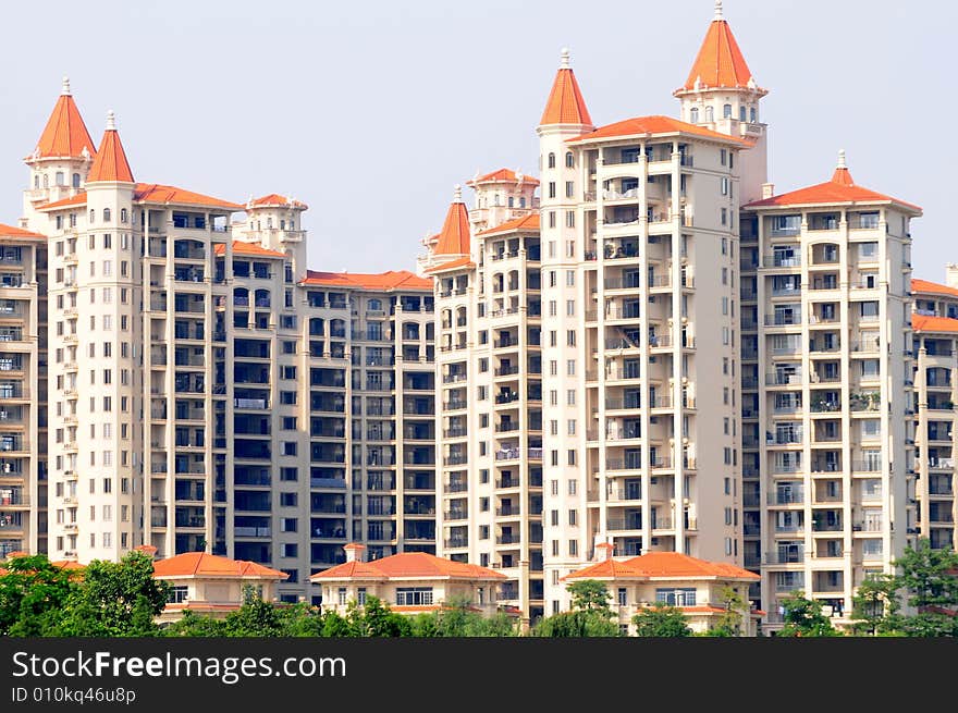 The apartment building with red spires