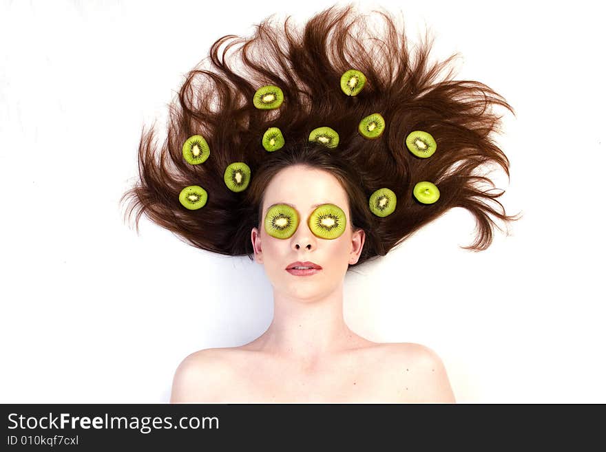 Girl with kiwi fruit in her hair. Girl with kiwi fruit in her hair