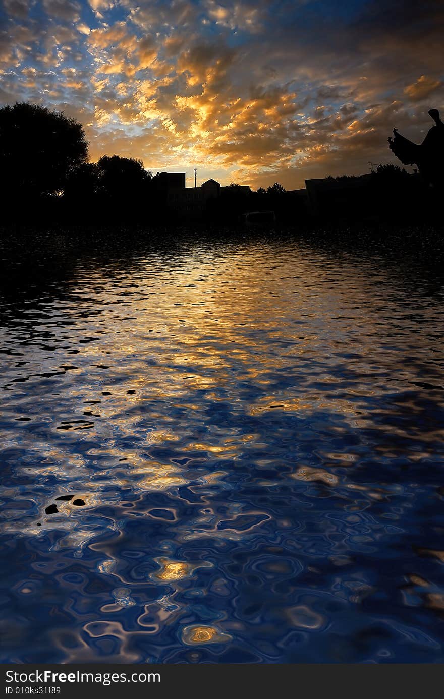 Orange sunrise on reflected water surface. Orange sunrise on reflected water surface