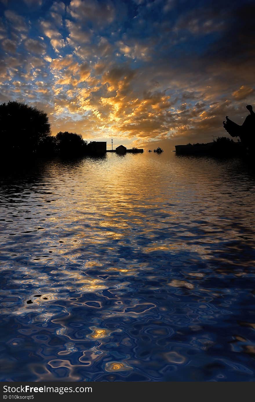 Orange sunrise on reflected water surface. Orange sunrise on reflected water surface