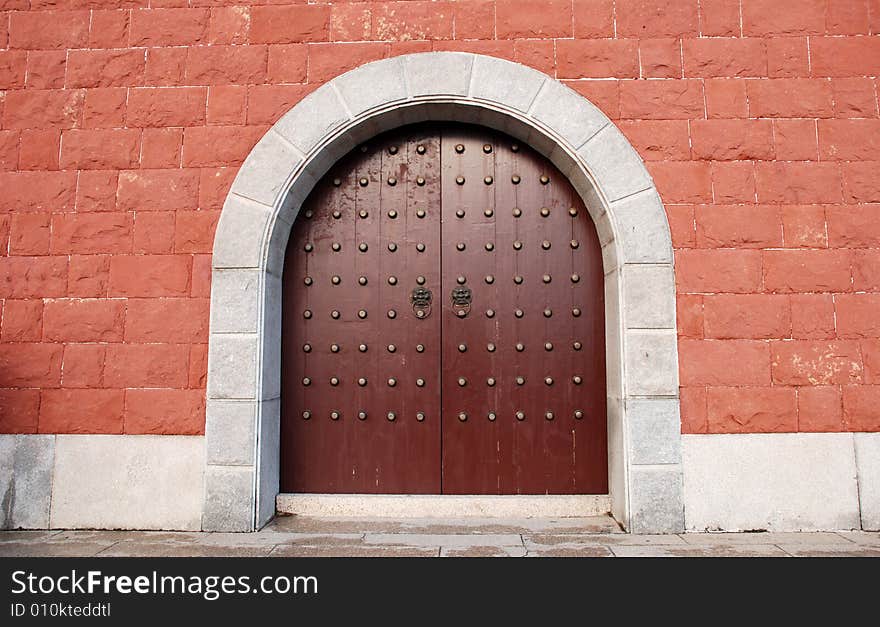 The Chinese ancient red wall and  wood door of an imperial palace. The Chinese ancient red wall and  wood door of an imperial palace.