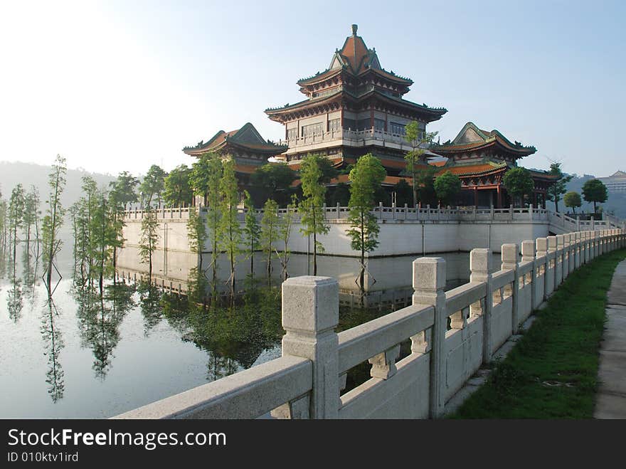 The stone railings along the lakeside, the storeied pavilion on stone terrace in  the lake,an imperial garden,Beijing,China. The stone railings along the lakeside, the storeied pavilion on stone terrace in  the lake,an imperial garden,Beijing,China.