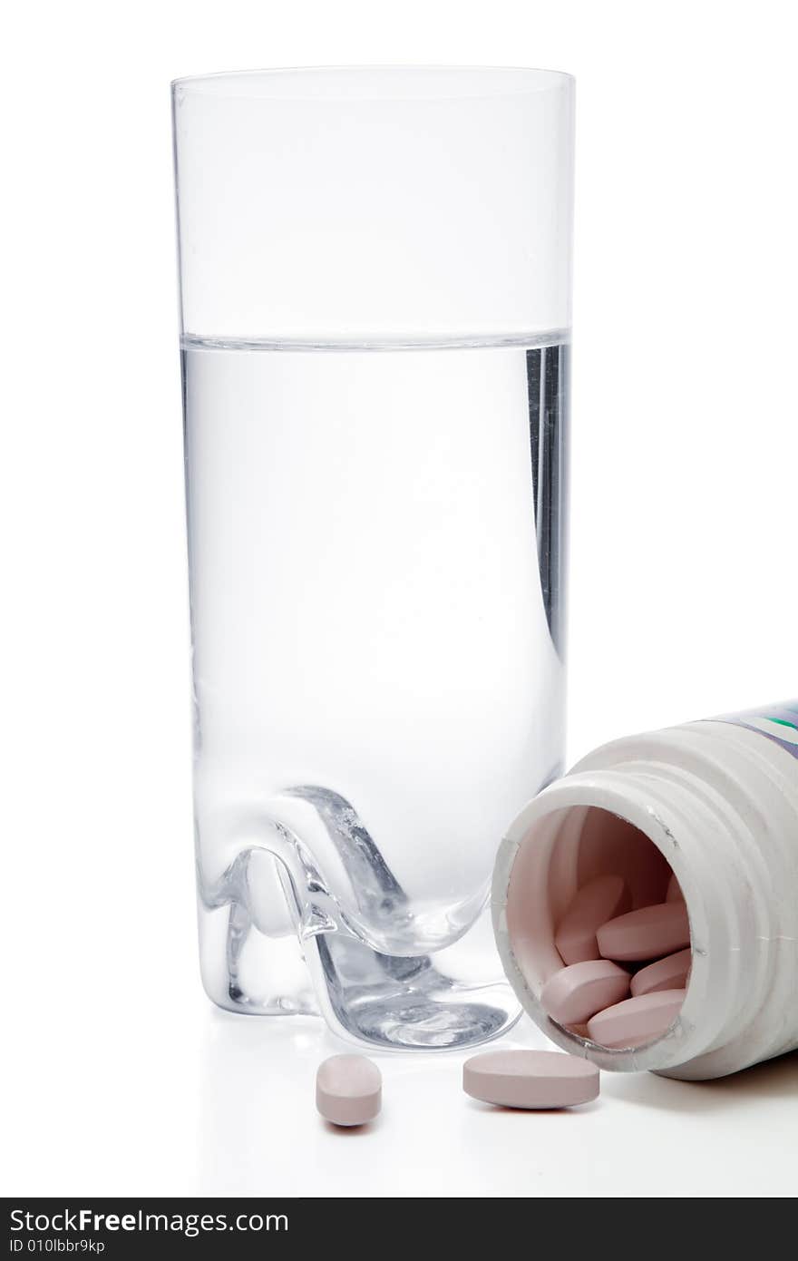 Glass with water and pills in container, isolated