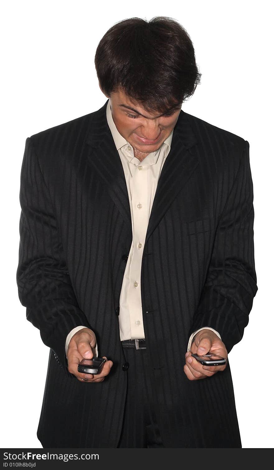 Angry businessman holding two mobile phones