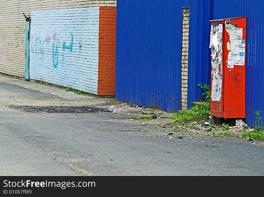 Close-up view of corner and painted wall with graffiti