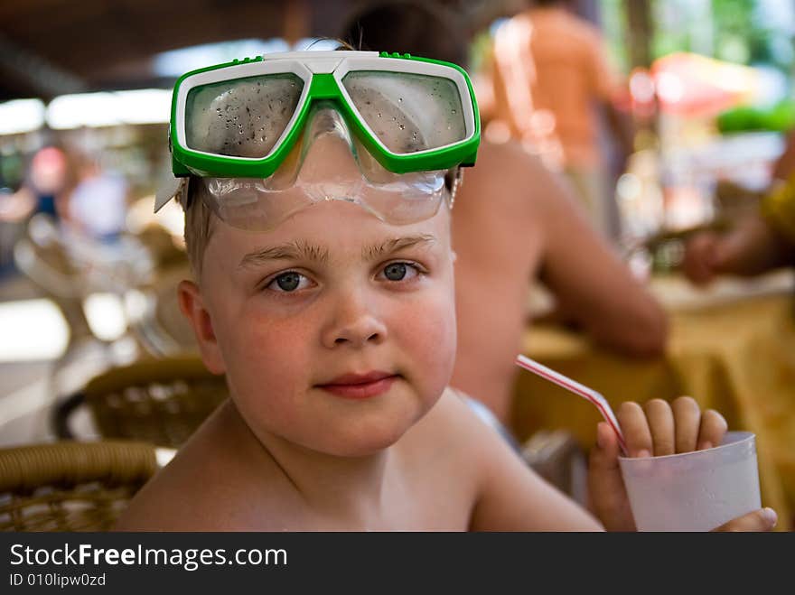 Boy on vacations with mask and cocktail