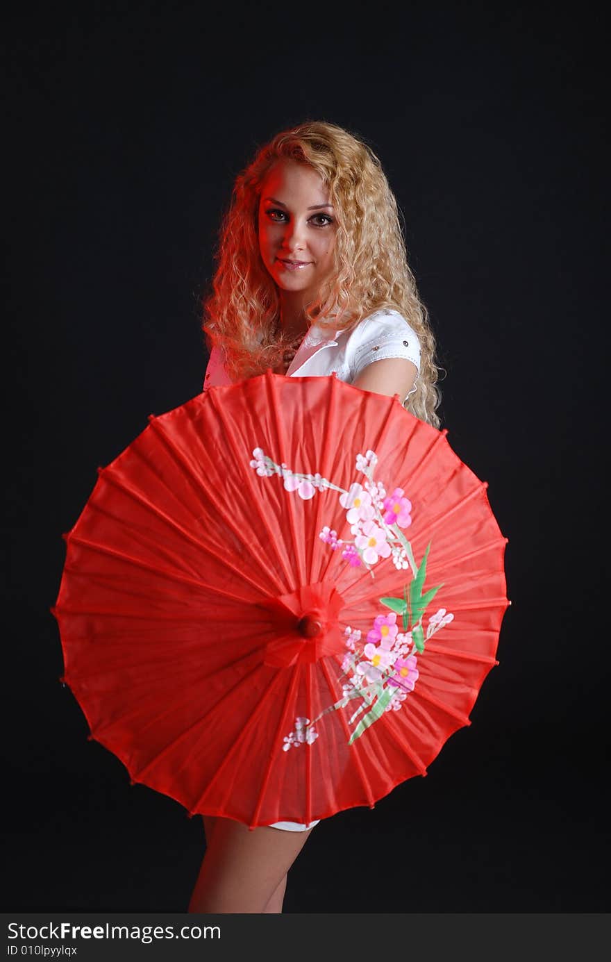 Portrait of young beauty woman in white dress at black background with umbrella. Portrait of young beauty woman in white dress at black background with umbrella