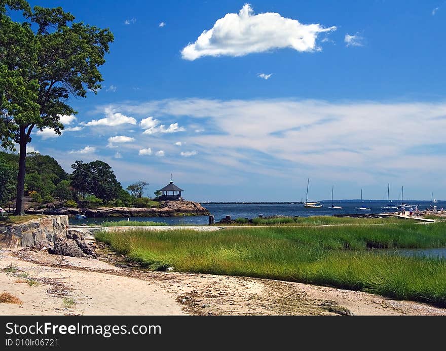 View of beach with gazebo and distant sailboats. View of beach with gazebo and distant sailboats.