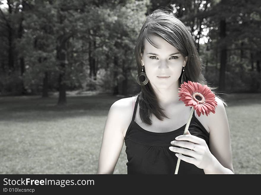 Young Women With Flower Relaxing In The Park