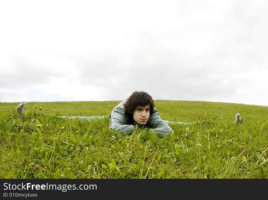 Yogi man sitting at the twine on the grass. Yogi man sitting at the twine on the grass