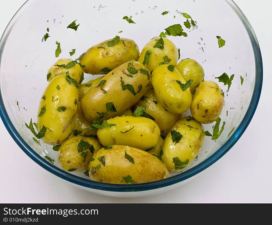 Boiled potatoes with oil and mint ready for transferring into a serving dish. Boiled potatoes with oil and mint ready for transferring into a serving dish.