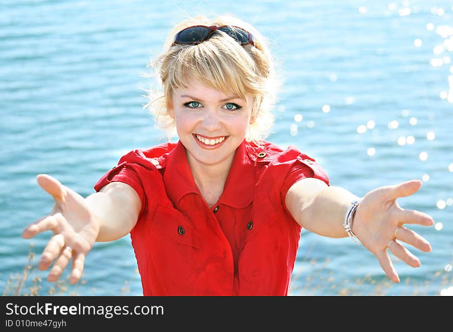 Beautiful blonde in a red dress on a sea resort. Beautiful blonde in a red dress on a sea resort