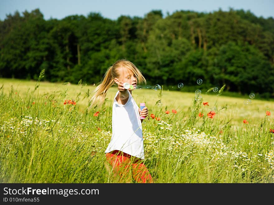 Girl making soap bubbles