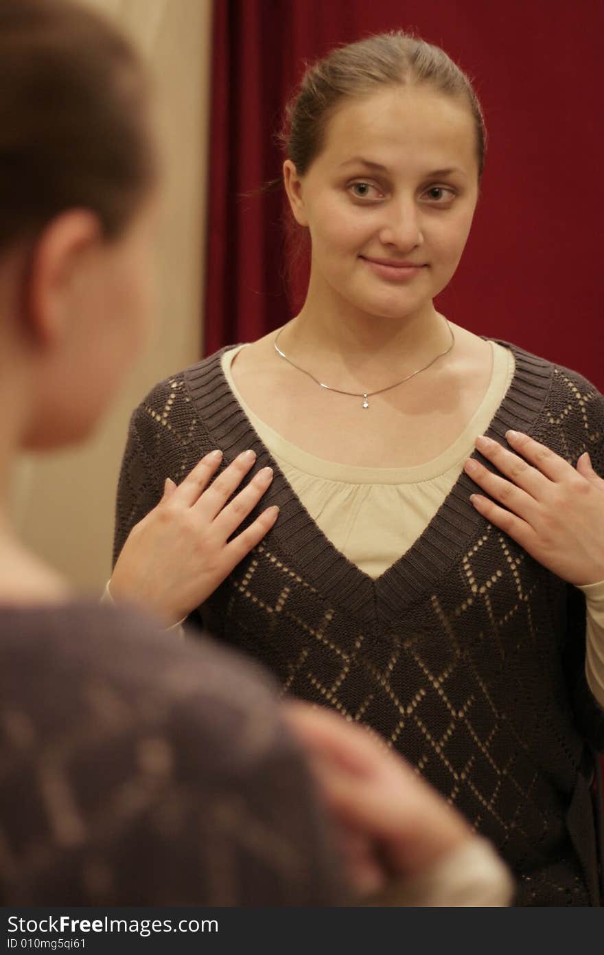 The girl at a mirror in a clothes shop