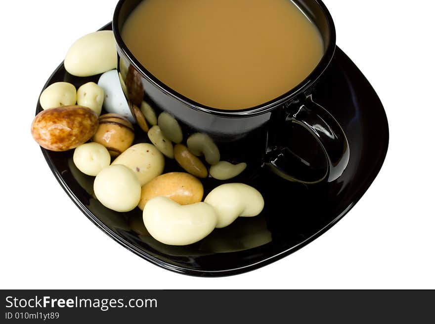 Black coffee cup with milk and candies