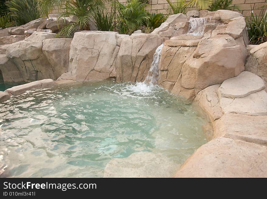 Tropical Custom Pool Jacuzzi with rocks and waterfalls.