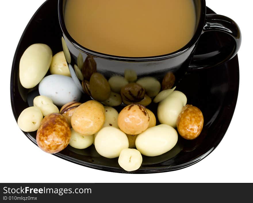 Coffee cup with milk and candies