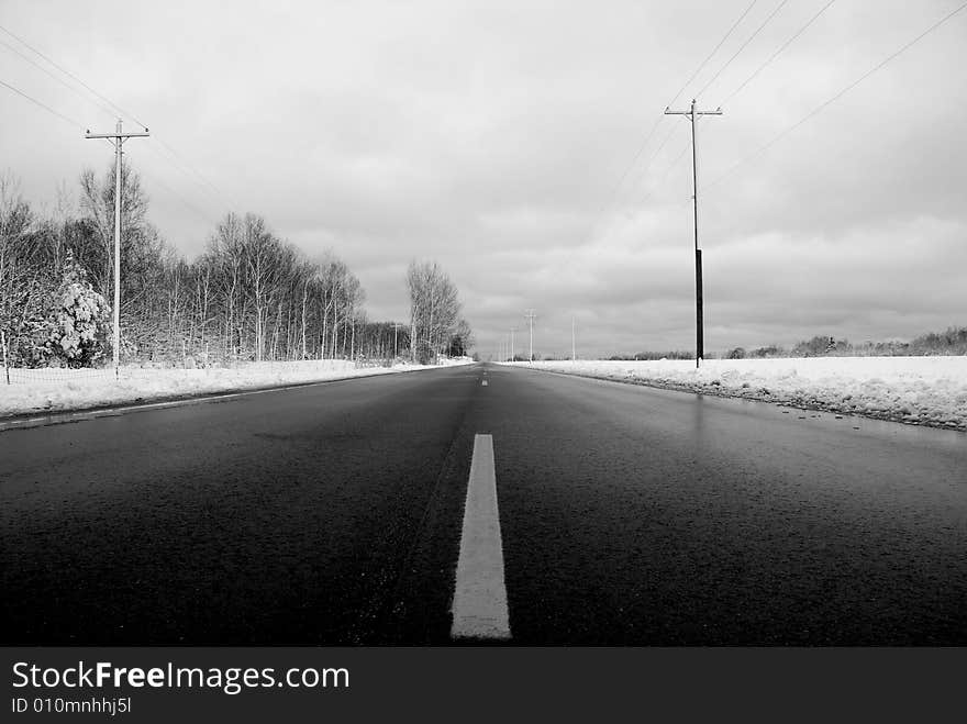 Highway 10 in Michigan.  The cold winter black ice covered road. Dangerous, yet beautiful in this chilling frozen environment. Highway 10 in Michigan.  The cold winter black ice covered road. Dangerous, yet beautiful in this chilling frozen environment.