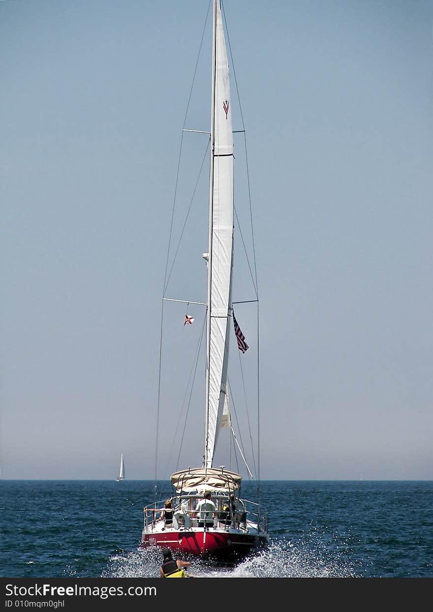 Jet ski jumping the sailboat's wake. Jet ski jumping the sailboat's wake.