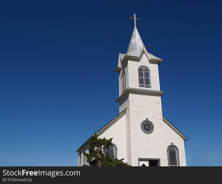 Rural White Church against bright blue sky