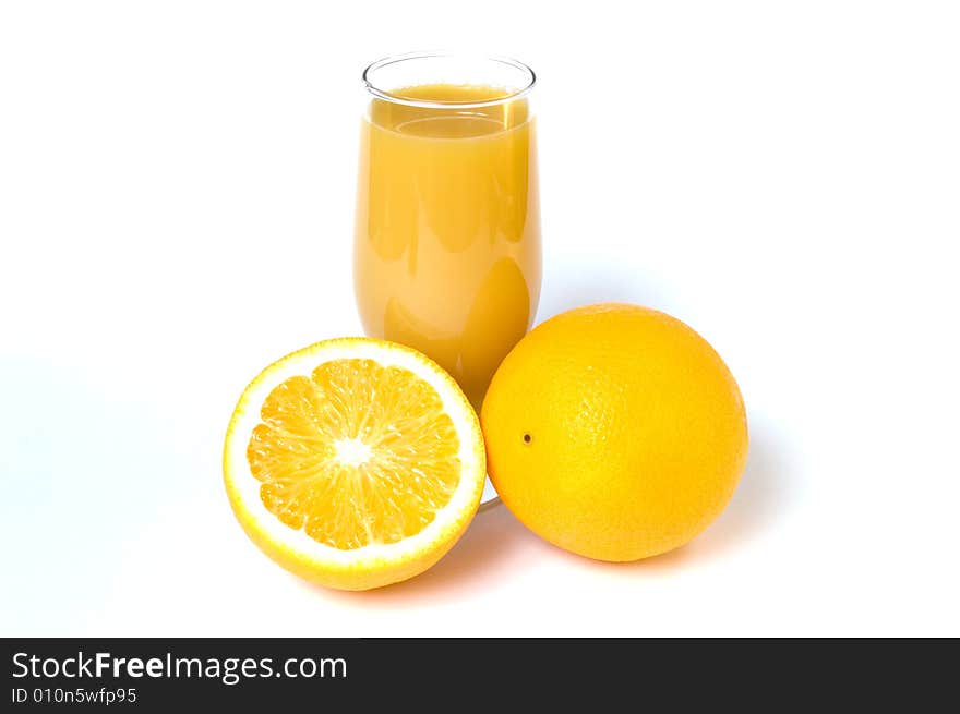 Two oranges and orange juice in the glass isolated on white. Two oranges and orange juice in the glass isolated on white