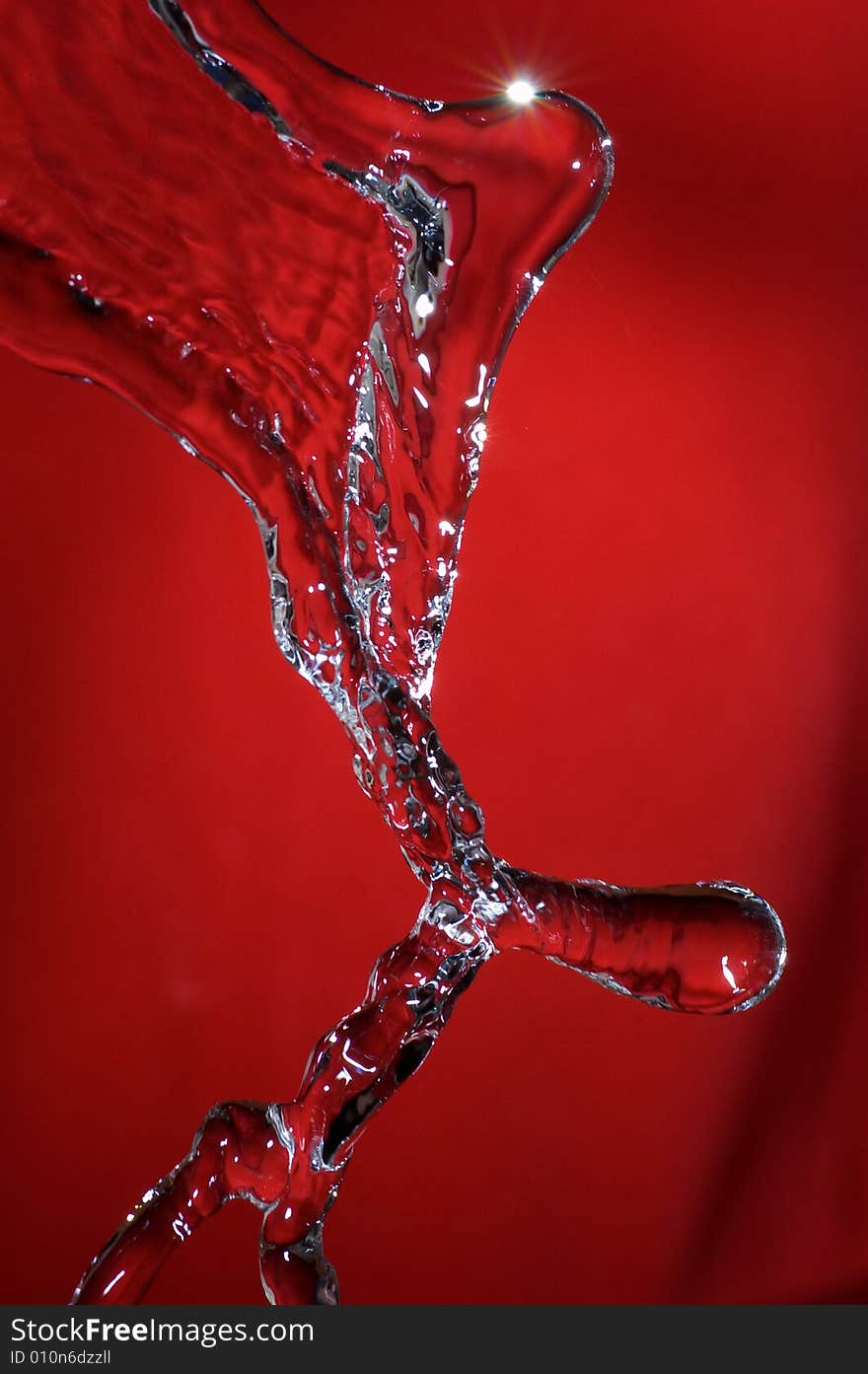 Flowing water stream over colored background