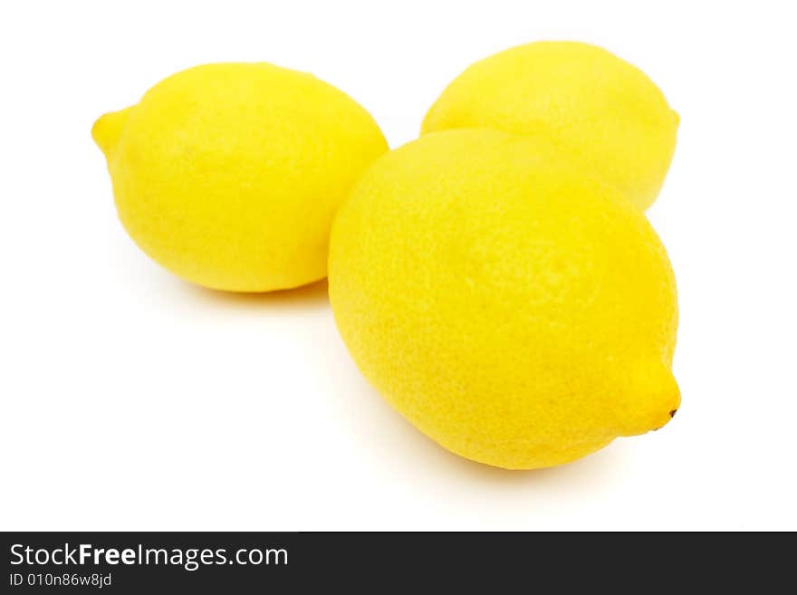 Three lemons put together on white background.