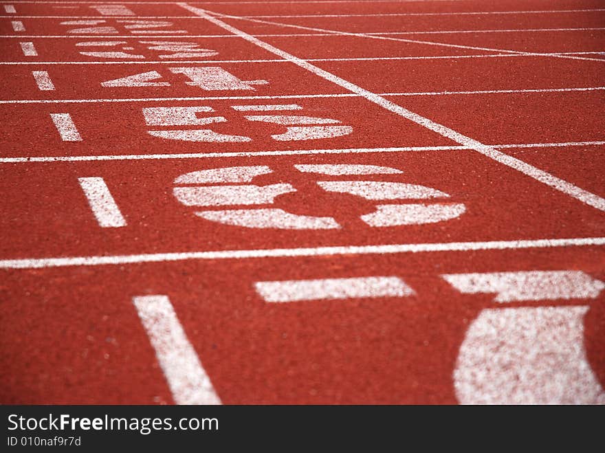 Finish line and track numbers of red running tracks. Finish line and track numbers of red running tracks