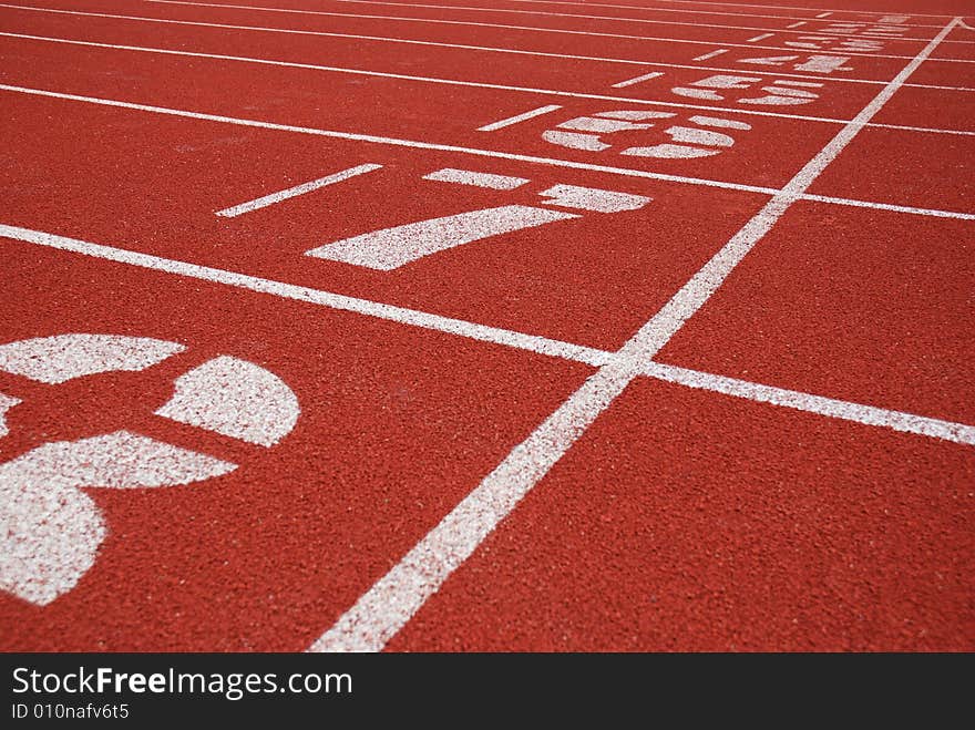 Finish line and track numbers of red running tracks. Finish line and track numbers of red running tracks