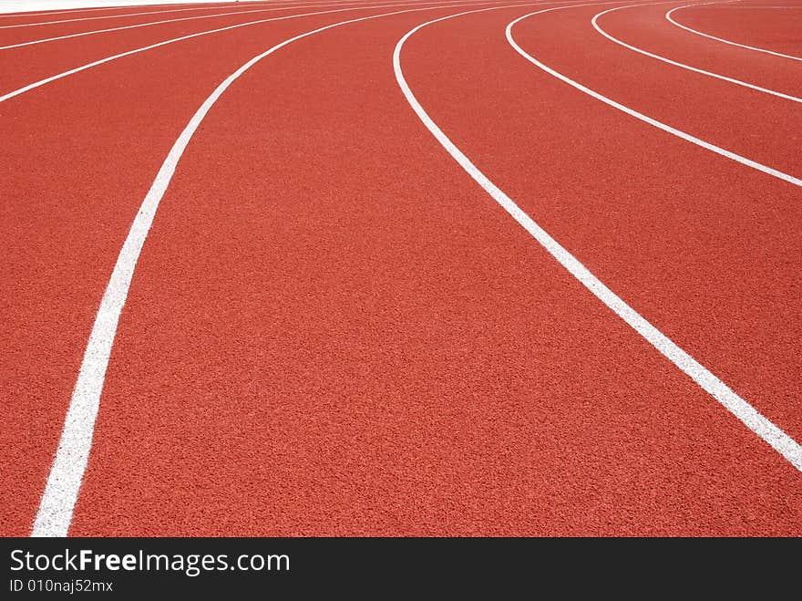 Curved red running tracks in outdoor arena