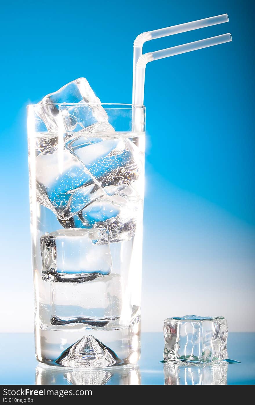 Tall iced drink with a cold blue lighting and straws. Tall iced drink with a cold blue lighting and straws