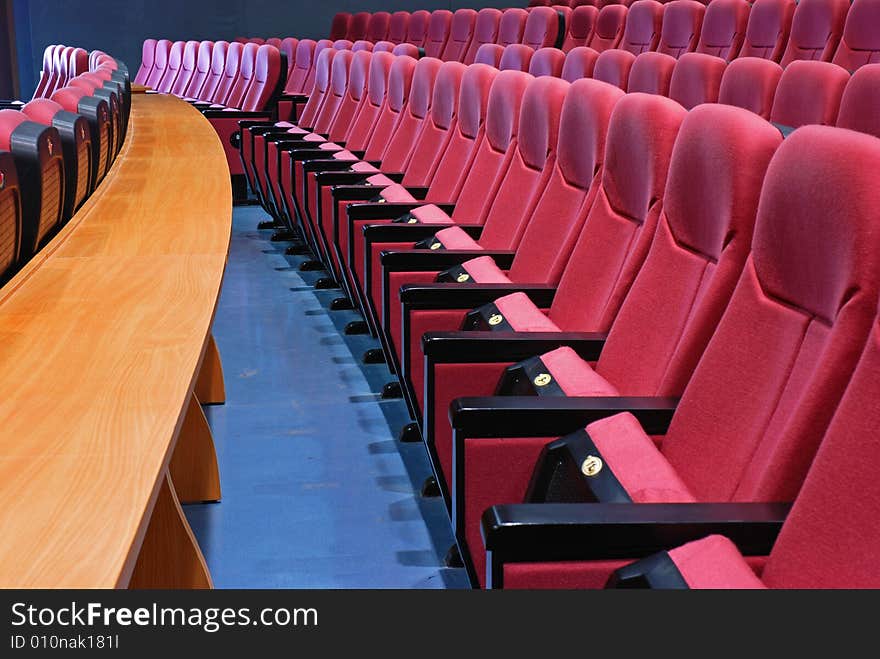 Empty cinema seats with long table in front