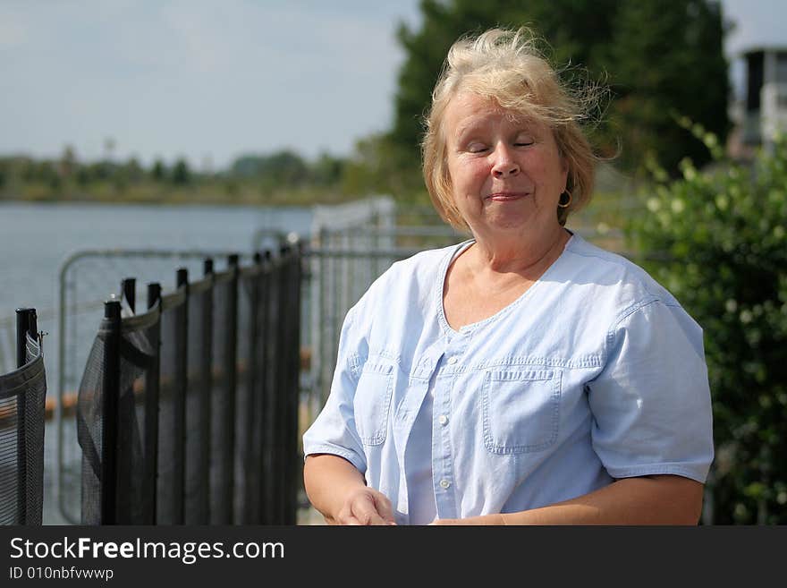 Photo of a happy senior by the waterfront