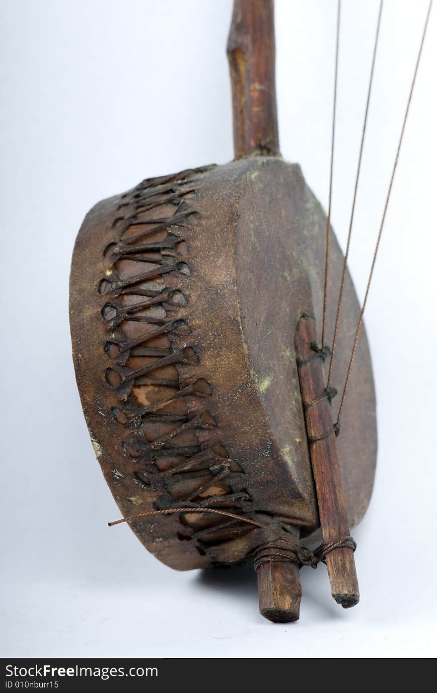 Close up of a banjo hand crafted from raw materials, typically found in countries of central and southern africa, usually hand made by shepherds, and used by them to to create a familiar tune for the animals to follow. Close up of a banjo hand crafted from raw materials, typically found in countries of central and southern africa, usually hand made by shepherds, and used by them to to create a familiar tune for the animals to follow.