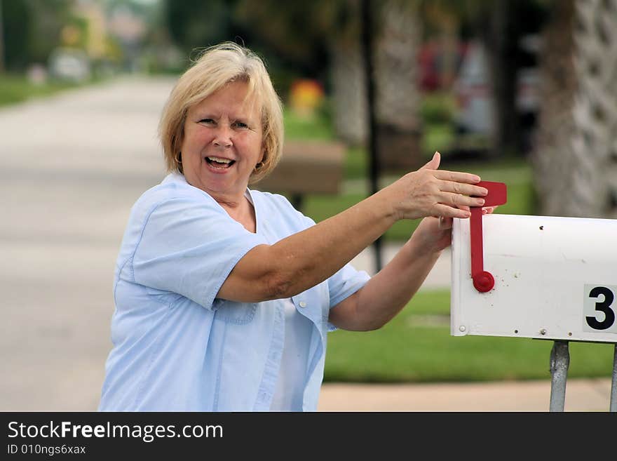 Photo of a senior checking the mail box. Photo of a senior checking the mail box