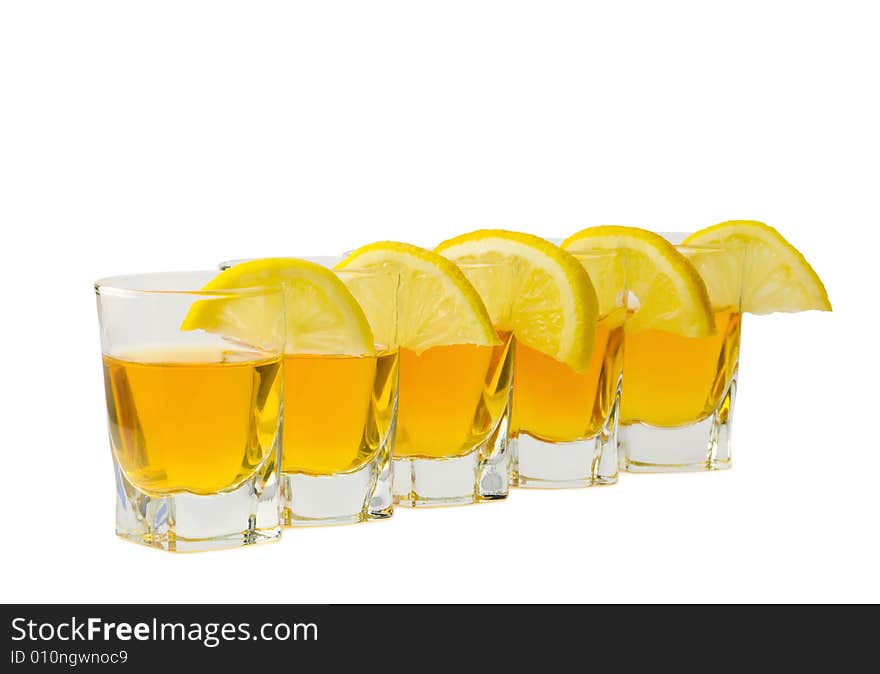 Drink and slices of a fresh lemon isolated on white background. Drink and slices of a fresh lemon isolated on white background.