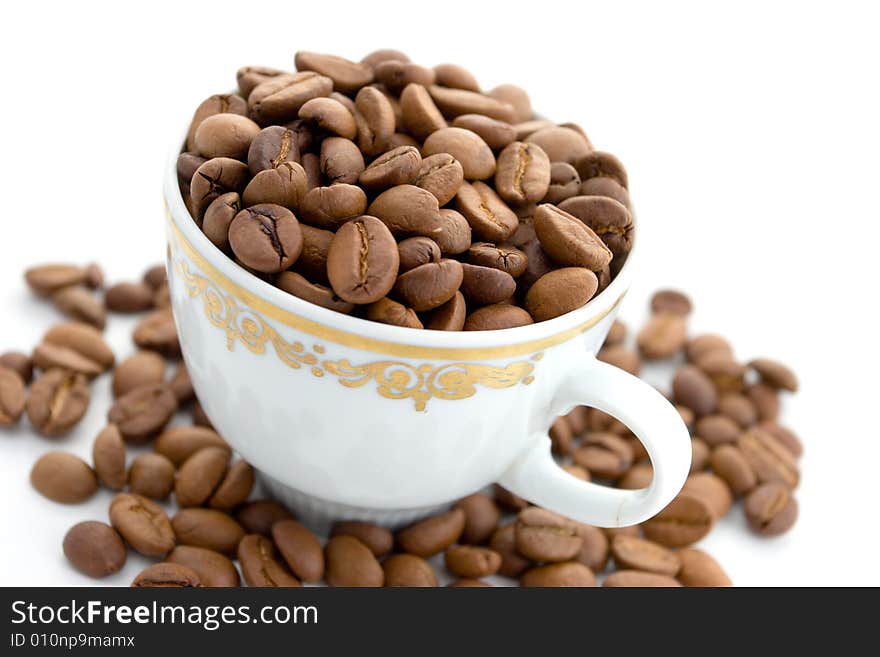 Coffee beans in the cup on a white background