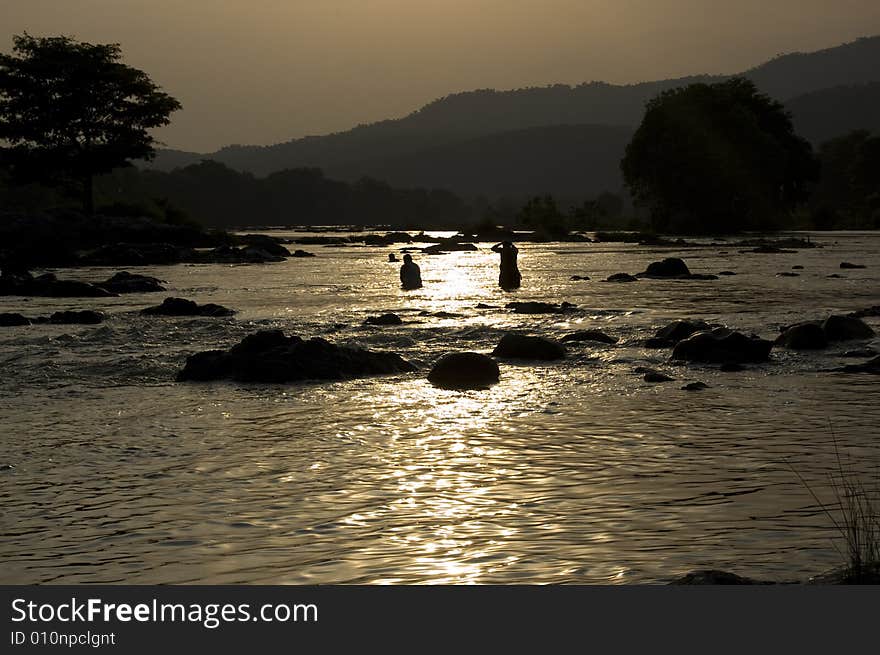 Bright and fabulous sunset in the bank of river which is in a golden color