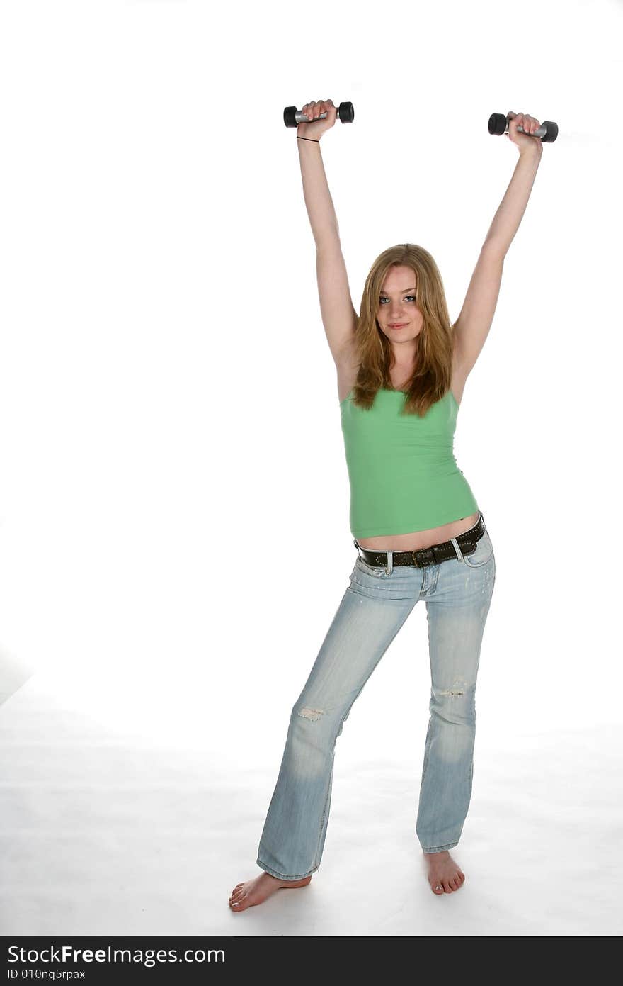 Young woman lifting barbells over head