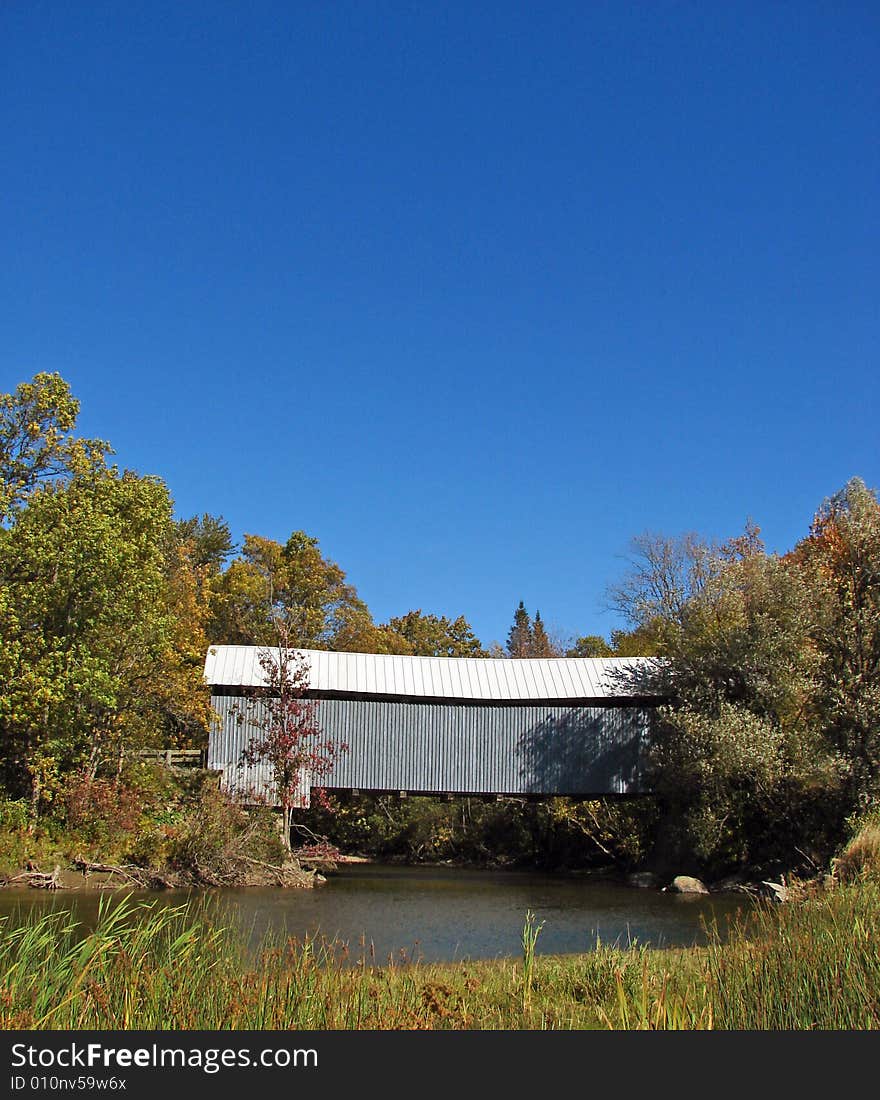 Covered bridge in autumn in the province of Quebec in Canada. Covered bridge in autumn in the province of Quebec in Canada