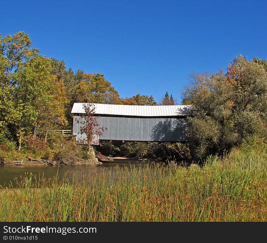 Covered bridge in autumn in the province of Quebec in Canada. Covered bridge in autumn in the province of Quebec in Canada