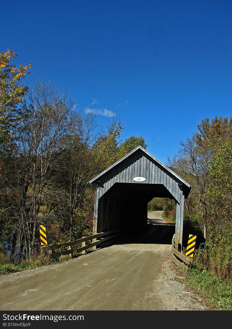 Covered bridge in autumn in the province of Quebec in Canada. Covered bridge in autumn in the province of Quebec in Canada